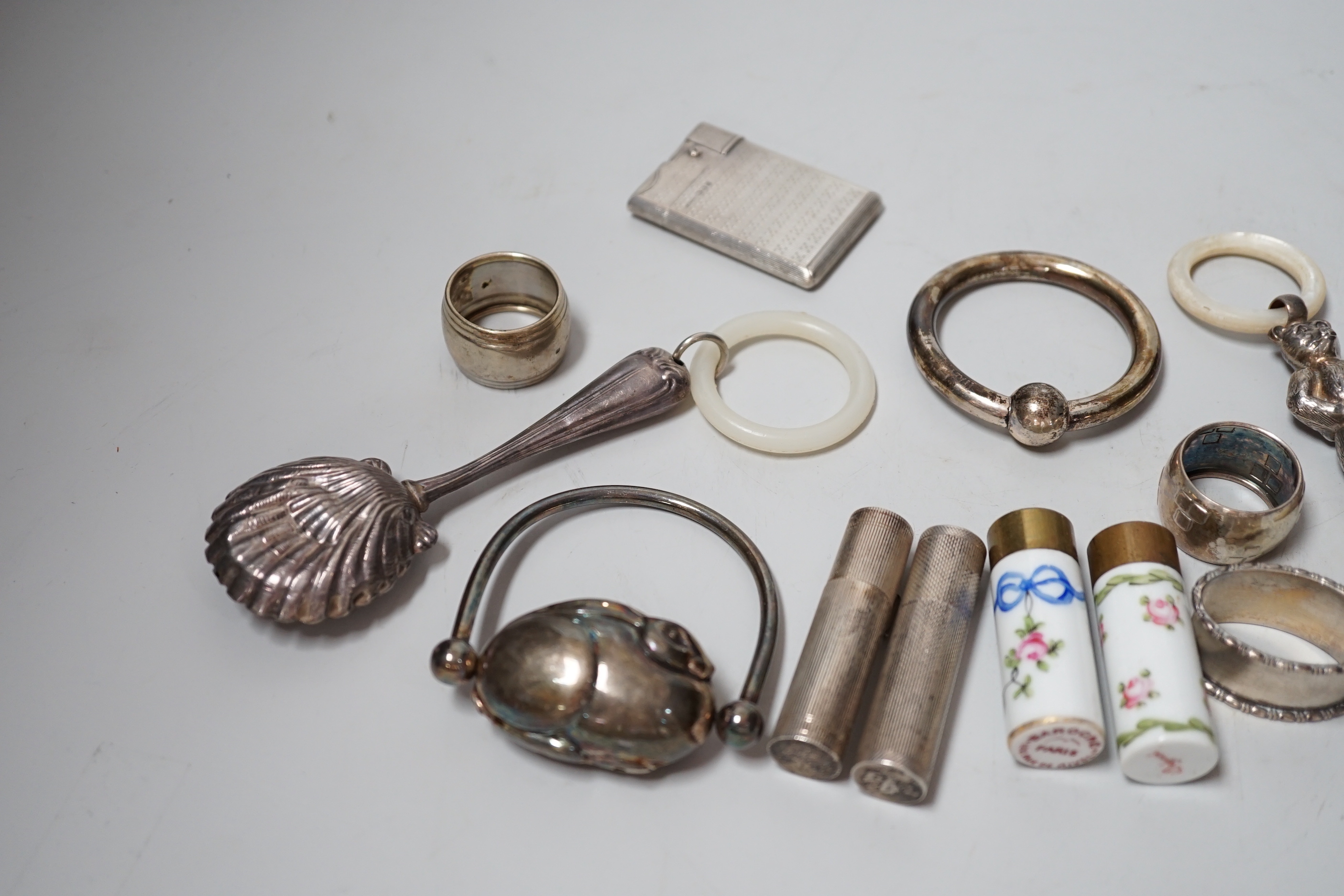 Sundry small silver and other items including teethers, rattles, Asprey & Co silver mounted lighter, etc.